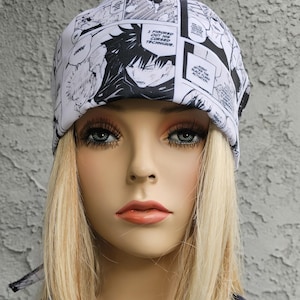 May include: A white and black bandana with a manga style print featuring a character with black hair and a black and white outfit. The text "I figured out his cursed technique." is visible on the bandana.