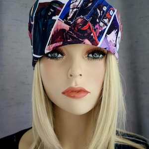 May include: A woman wearing a black headband with a colorful anime print. The headband features various characters and scenes from different anime series.