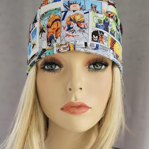 May include: A white scrub hat with a colorful anime print featuring characters from Dragon Ball Z. The print includes images of Goku, Vegeta, and Piccolo.
