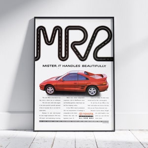 May include: A vintage print advertisement for the Toyota MR2 sports car. The ad features a red MR2 driving on a winding road, with the text "MR2. Mister, it handles beautifully." and the Toyota logo.