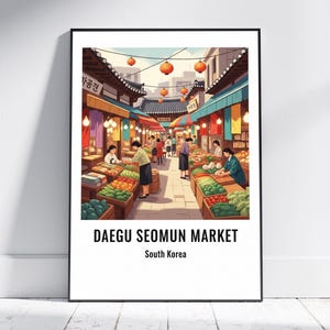 May include: A framed print of Daegu Seomun Market in South Korea. The illustration depicts a bustling marketplace with vendors and customers. Colorful produce is displayed under awnings, and red lanterns hang overhead. The text "DAEGU SEOMUN MARKET" and "South Korea" are at the bottom.