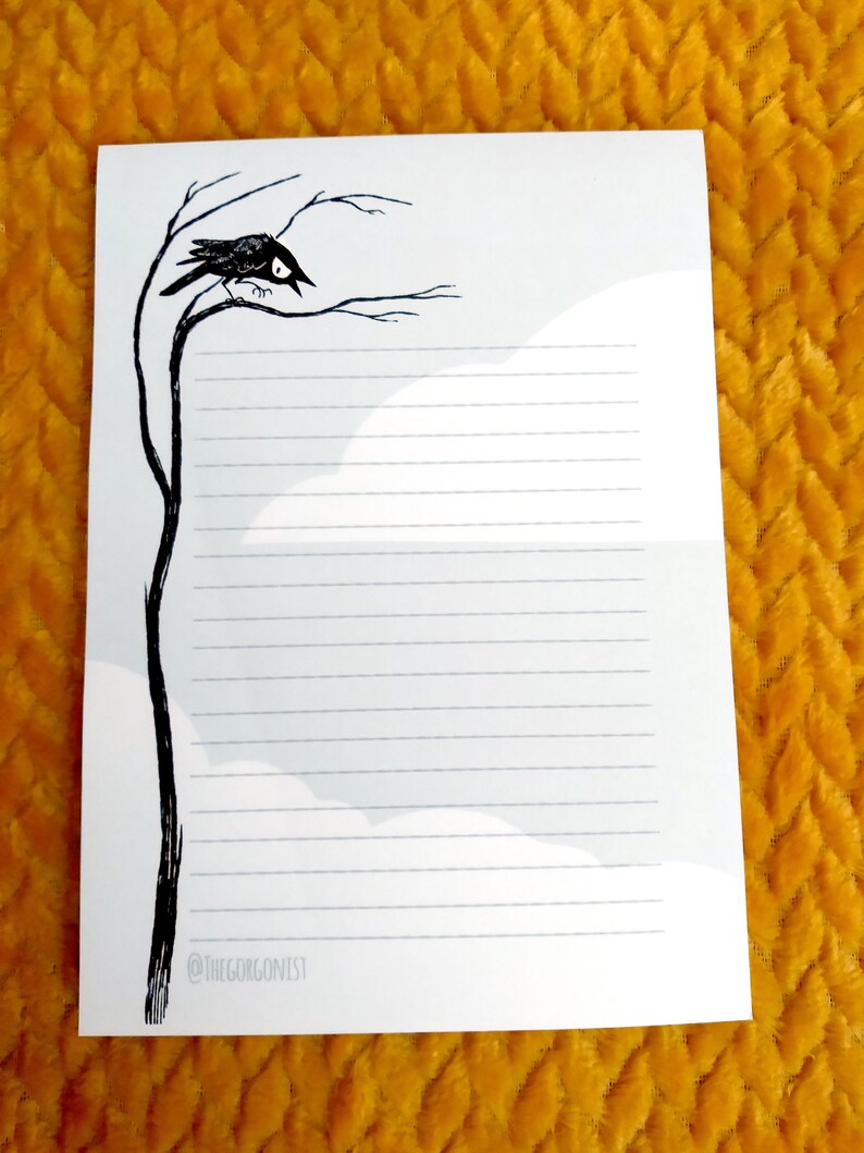 May include: A white lined paper notepad with a black and white illustration of a crow perched on a bare branch. The text "@thegorgonist" is at the bottom of the page.