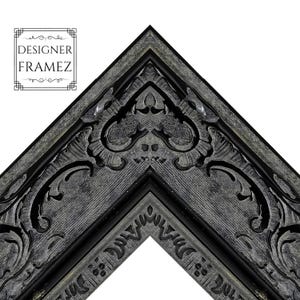 May include: Close-up of a corner of a decorative picture frame. The frame is black with ornate, carved details and a distressed gray finish. The text "DESIGNER FRAMEZ" is in the upper left corner.