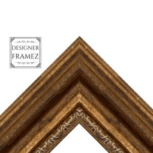 May include: An ornate picture frame corner section featuring a dark bronze finish with a distressed texture. The frame has a multi-tiered profile with a decorative inner edge pattern. The text DESIGNER FRAMEZ is printed in black on the upper left.
