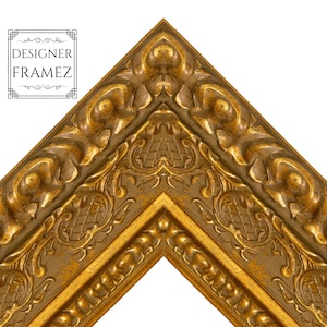 May include: Close-up of a corner of a gold-colored picture frame. The frame has ornate, detailed carvings and a distressed finish. The text "DESIGNER FRAMEZ" is in the upper left corner.
