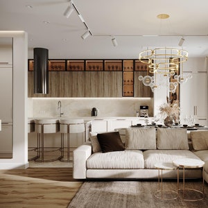 Può includere: Un soggiorno moderno con un divano angolare bianco, due tavolini dorati e un grande lampadario dorato con sfere di vetro. La stanza ha un pavimento in legno e un tappeto. La cucina è visibile sullo sfondo con armadietti bianchi e una cappa aspirante nera.