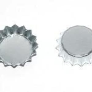 May include: Two silver bottle caps with a starburst design around the edge.