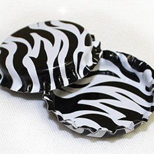 May include: Two black and white zebra patterned bottle caps.