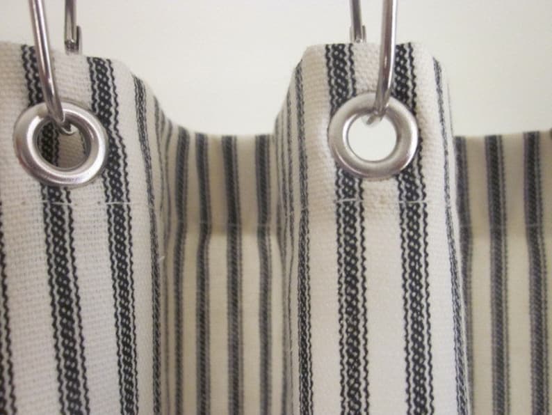 close up photograph of a black and cream stripe fabric shower curtain