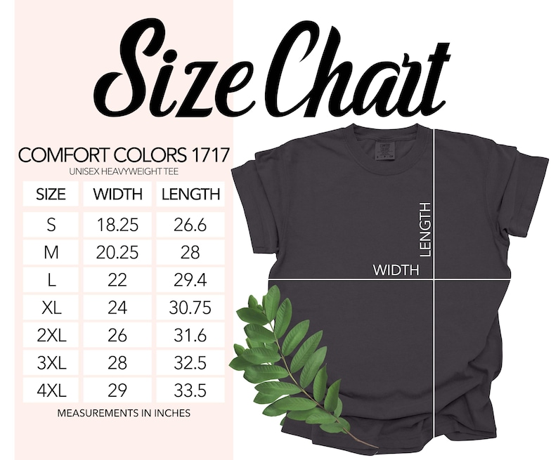 Op de afbeelding: Een donkergrijs Comfort Colors 1717 unisex heavyweight t-shirt met een maattabel. De maattabel toont afmetingen in inches voor maten S t/m 4XL. Het shirt heeft een groene blad tak in de hoek.