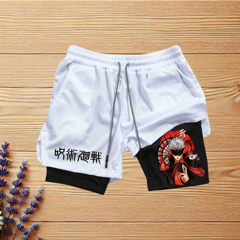 May include: White athletic shorts with black trim and a black inner layer. The shorts have a drawstring waist and feature a graphic print of a character with red and black accents. The text "吸新知 20 弊" is printed on the shorts.