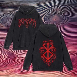 May include: Black hooded sweatshirt with a red graphic of the Berserk logo and skull imagery on the back. The front of the sweatshirt has the word "Berserk" in red lettering.