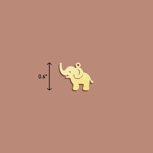 May include: A gold-coloured metal elephant charm, approximately 0.6 inches tall.