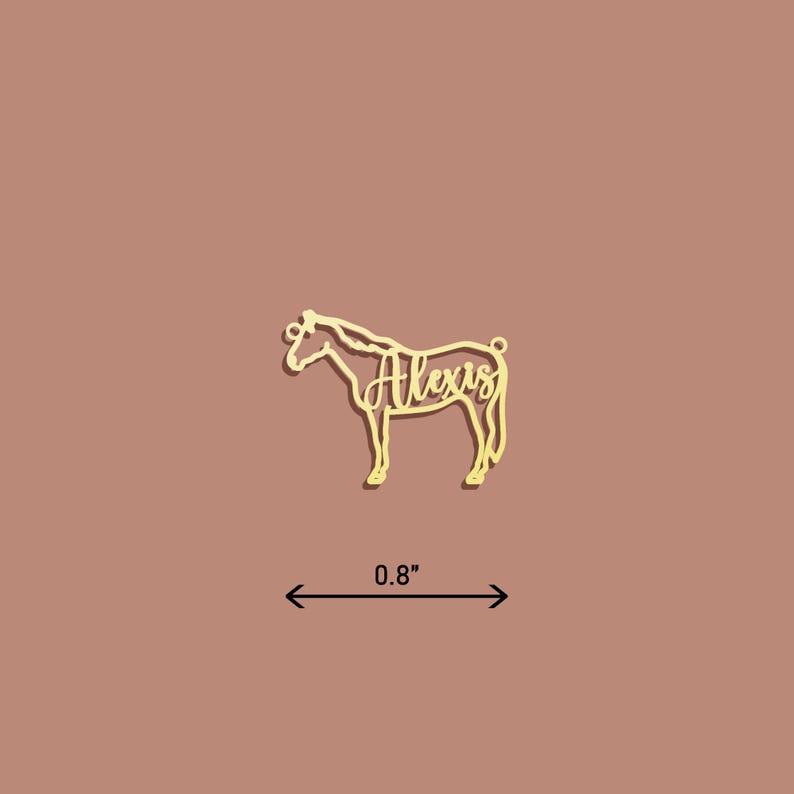 May include: Gold-colored metal horse silhouette ornament with the name "Alexis" cut out inside. The ornament is 0.8 inches wide.