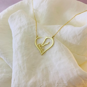 May include: Gold necklace with a heart-shaped pendant featuring a horse silhouette and the name "Charlie" inscribed inside.