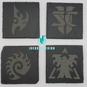 May include: Four black square slate coasters with different gray designs. The designs are stylized logos of the four factions from the video game StarCraft. The logos are the Terran, Zerg, Protoss, and the StarCraft logo.