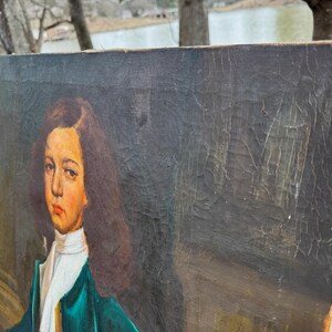 Pode incluir: Uma pintura de retrato antigo de uma pessoa com cabelo castanho comprido, usando uma camisa de colarinho branco e um casaco verde-azulado. A pintura tem um fundo escuro e &eacute; exibida em uma moldura de madeira.