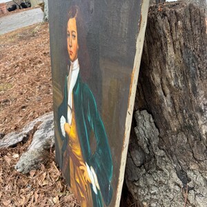 Pode incluir: Uma pintura de retrato antigo de uma pessoa com um casaco verde e um colete amarelo. A pintura tem um fundo escuro e &eacute; emoldurada com uma moldura de madeira de cor clara. O sujeito est&aacute; olhando para o espectador.