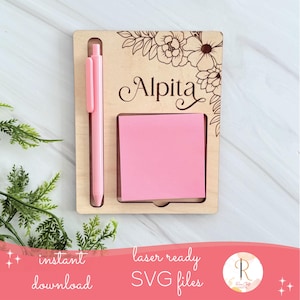 Peut inclure: Un organiseur de bureau en bois avec un stylo rose et des notes autocollantes. L'organisateur porte le nom "Alpita" gravé, ainsi que des motifs floraux. Les mots "téléchargement instantané" et "fichiers SVG prêts pour le laser" sont également visibles.