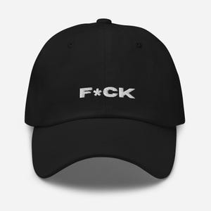 Könnte beinhalten: Eine schwarze Baseballkappe mit dem weißen, gestickten Wort "F*CK" auf der Vorderseite.