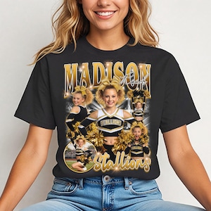 May include: Black t-shirt featuring a collage of images of a cheerleader in a cheerleading uniform with gold accents. The shirt has the name "Madison Reed" and the word "Stallions" in gold lettering.