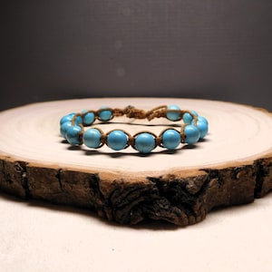 Adjustable turquoise macrame bracelet crafted with brown cotton cord - a unisex Boho-style western jewelry gift.