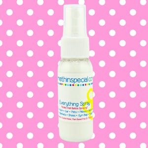 May include: A clear spray bottle with a white liquid and a white spray nozzle. The label reads "Everything Spray" with a list of items to spray. The background is a pink polka dot pattern.