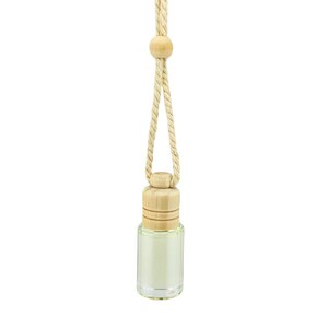 May include: A small, clear glass bottle with a light green liquid inside, topped with a cylindrical wooden cap. The bottle is suspended by a thick, beige twisted rope cord that features a small, round wooden bead accent near the top.