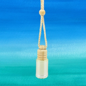 May include: A clear glass car air freshener bottle with a wooden cap and a beige rope for hanging. The bottle is filled with a light-colored liquid. The background is a gradient of blue and teal.