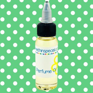 May include: A clear glass bottle of perfume oil with a black cap and a white label. The label has the text "Perfume Oil" in blue and yellow. The background is a green color with white polka dots. The website address "methinspecial.com" is also visible.