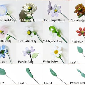 May include: A collection of glass flowers and leaves on thin stems, including a blue morning glory, white chrysanthemum, purple daisy, marigold, pink peony, white lily, white jade, red flower, blue flower, purple flower, white daisy, and various green leaves.