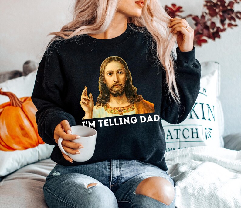 May include: Black sweatshirt with a graphic of Jesus saying "I'm telling Dad".