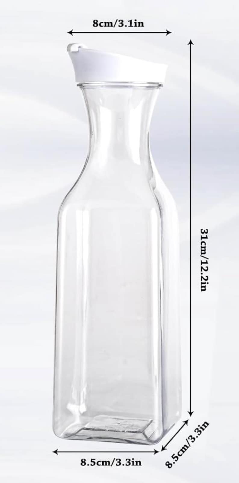 May include: A clear, rectangular-shaped pitcher with a white lid. The pitcher is 12.2 inches tall, 3.3 inches wide, and 3.1 inches across the top. The pitcher is designed for serving beverages.