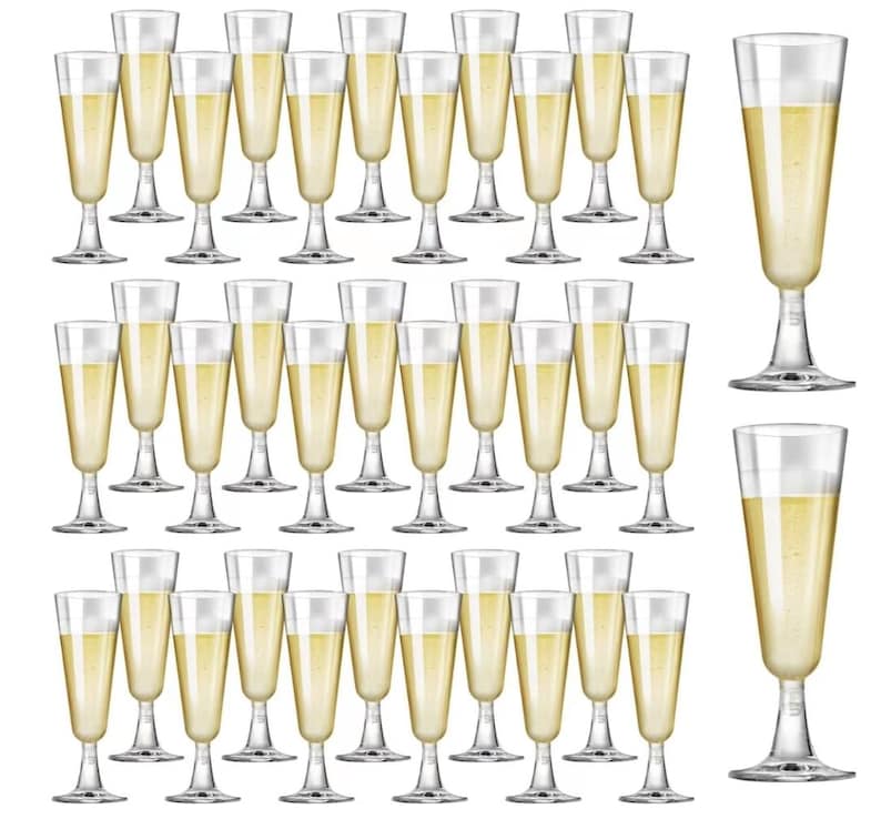 May include: A collection of clear champagne flutes filled with a golden liquid. The glasses have a classic design with a long stem and a slender bowl. The image showcases a variety of flutes, perfect for celebrations and events.