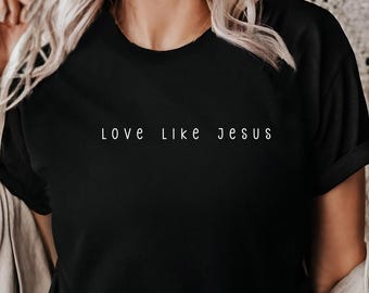 May include: A black t-shirt with the text "LOVE LIKE JESUS" printed in white on the front.