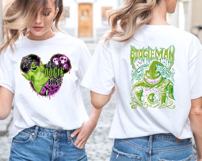 May include: White t-shirts with graphic designs. One shirt features a green and purple Oogie Boogie design in a Mickey Mouse shape with the text "It's Oogie Boogie". The other shirt has a green Oogie Boogie design with the text "Boogie Man".