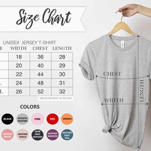 May include: A light gray unisex jersey t-shirt hanging on a wooden hanger. The image includes a size chart with measurements in inches for width, chest, and length, and a color chart with various options.