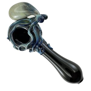 May include: A hand-blown glass pipe with an octopus design. The pipe features a dark blue and black color scheme with swirling patterns and a bulbous bowl. The octopus is detailed with blue tentacles and a light green head.