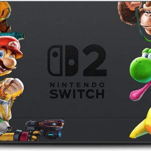 May include: A black Nintendo Switch console featuring a colorful design with various video game characters. The design includes Mario, Kirby, Pikachu, and other popular characters. The Nintendo Switch logo is visible.