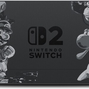 May include: A black Nintendo Switch console featuring a grayscale design with characters from various video games. The console has the Nintendo Switch logo and the number 2. Characters include Mario, Kirby, and Pikachu.