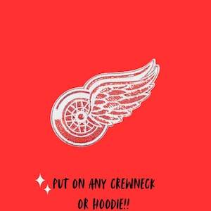 May include: A red background with a white and red logo of a wheel with wings. The text "PUT ON ANY CREWNECK OR HOODIE!!" is below the logo.