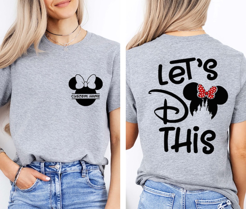May include: Gray t-shirt featuring a black Minnie Mouse silhouette with a bow and the text "CUSTOM NAME" on the front. The back of the shirt has the text "Let's Do This" with a Minnie Mouse design.