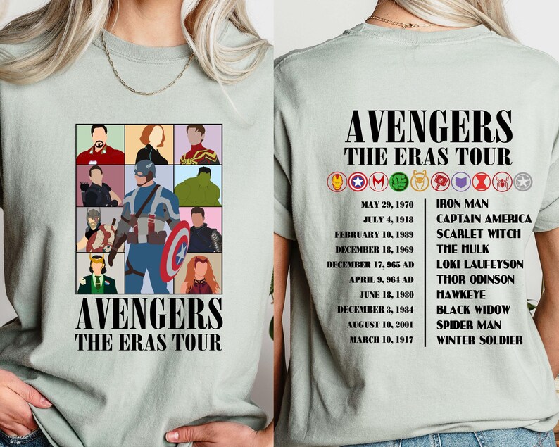 May include: A light green t-shirt with a graphic of the Avengers characters. The text "Avengers The Eras Tour" is printed on the shirt. The back of the shirt lists the Avengers characters and their first appearances.