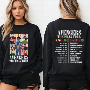 May include: Black sweatshirt with a graphic of the Avengers characters and the text "Avengers The Eras Tour". The back of the sweatshirt has a list of the Avengers characters with their first appearance dates.
