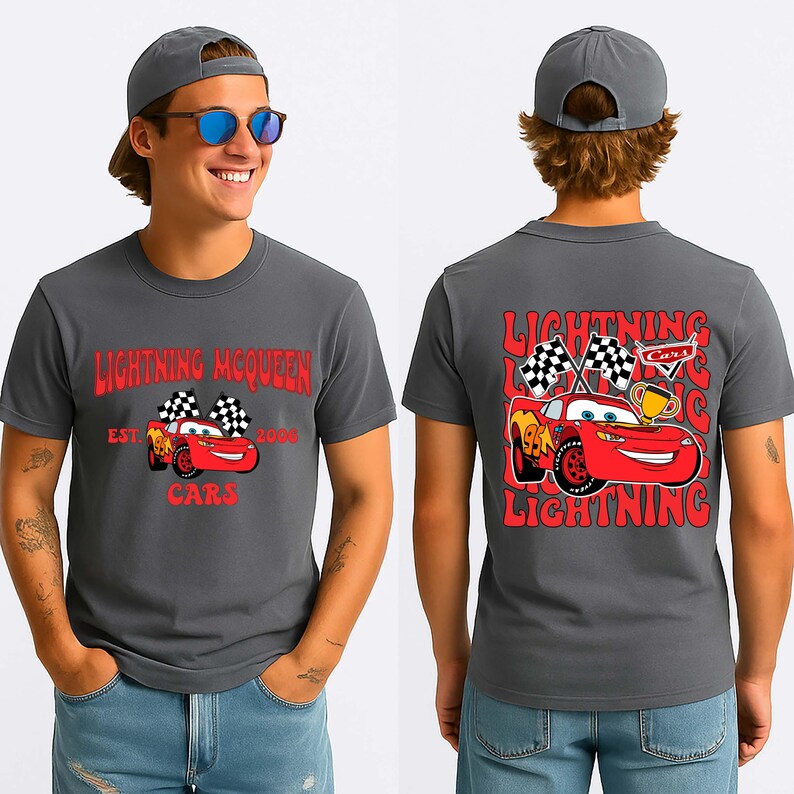 May include: Charcoal grey t-shirt featuring Lightning McQueen from the Cars film. The front graphic includes the text "Lightning McQueen" and "Cars", with a cartoon image of the car. The back graphic shows Lightning McQueen with checkered flags and a trophy.