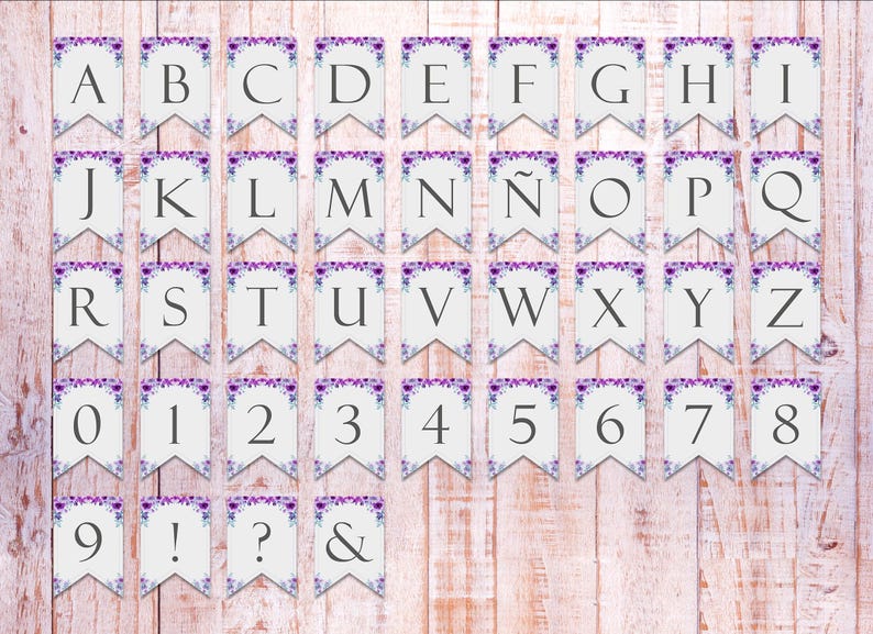 May include: A set of 36 white paper pennant flags with purple floral designs. The flags feature the alphabet, numbers 0-9, and punctuation marks such as an exclamation point, question mark, and ampersand.