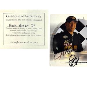 May include: An autographed trading card featuring Hank Parker Jr. in a racing uniform, with a certificate of authenticity. The card has a checkered flag background and the driver's signature.