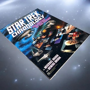 May include: A book titled "Star Trek Chronology: The History of the Future" by Michael Okuda and Denise Okuda. The cover features images of starships and characters against a blue and black space background.