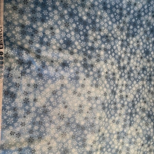 Snowflake White on Blue Christmas Fabric by Fabric Traditions