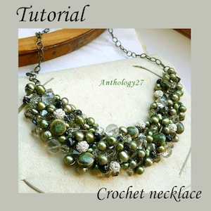 May include: A handmade crochet necklace featuring a variety of green beads, clear crystals, and silver accents. The necklace has a curved shape and is displayed on a neutral background. The word "Tutorial" is at the top and "Crochet necklace" at the bottom.